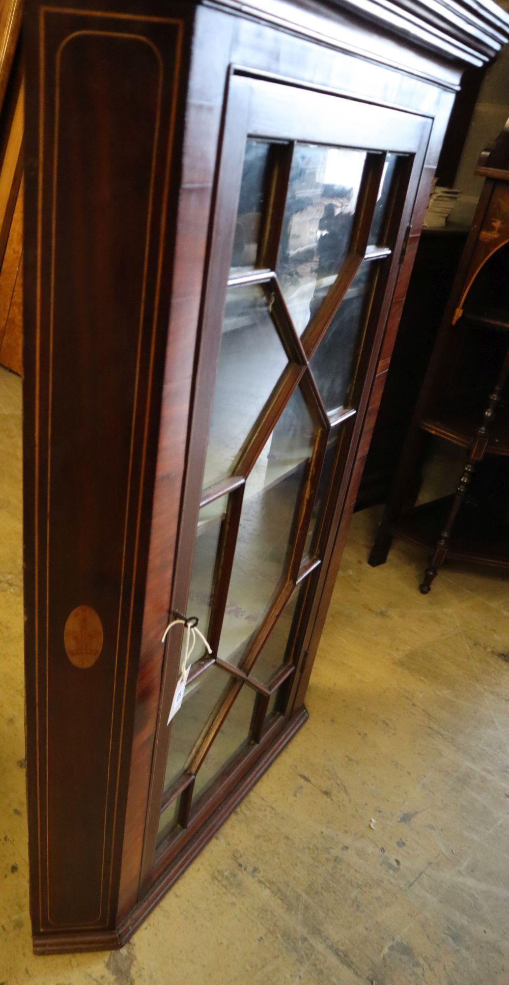 A George III inlaid mahogany hanging corner cabinet, width 83cm, depth 52cm, height 118cm